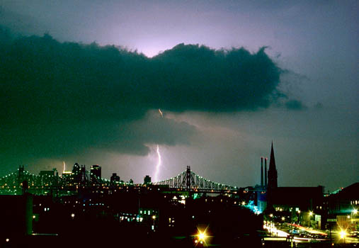 Greg Geffner, Horned Dark Cloud Silhouette Striking Queensburo Bridge. May 1989.